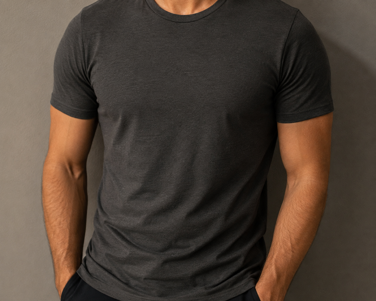 Man's torso in a fitted dark grey t-shirt, chest to waist, neutral studio lighting